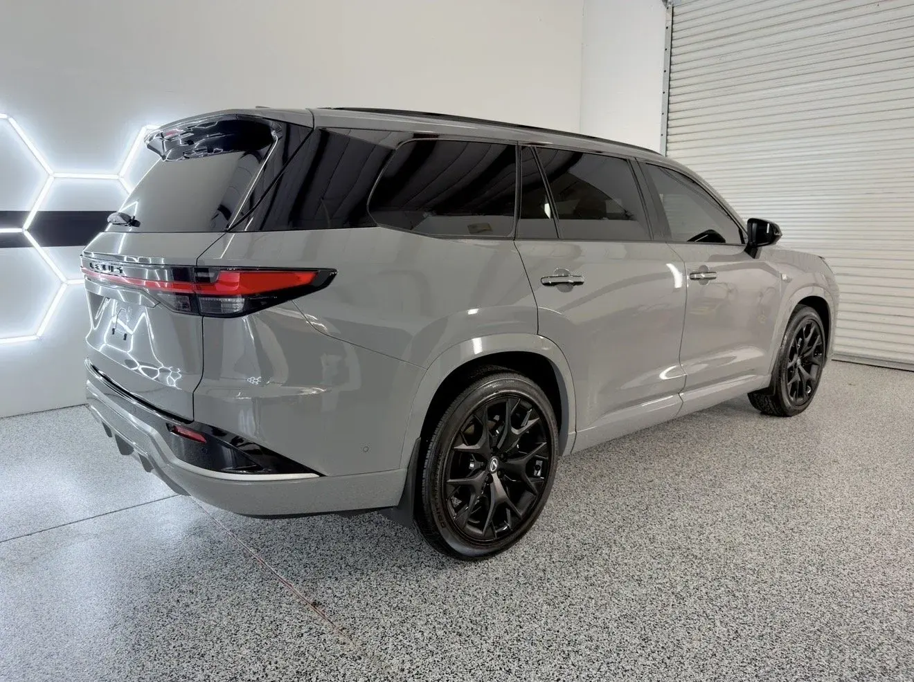 Gray three-row SUV in the Gulf Coast Auto Studio bay