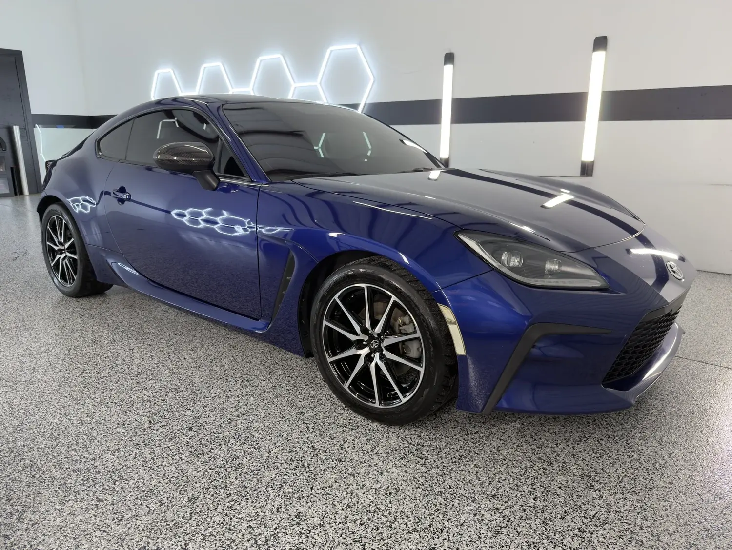 Blue Toyota GR86 sports car in the Gulf Coast Auto Studio bay