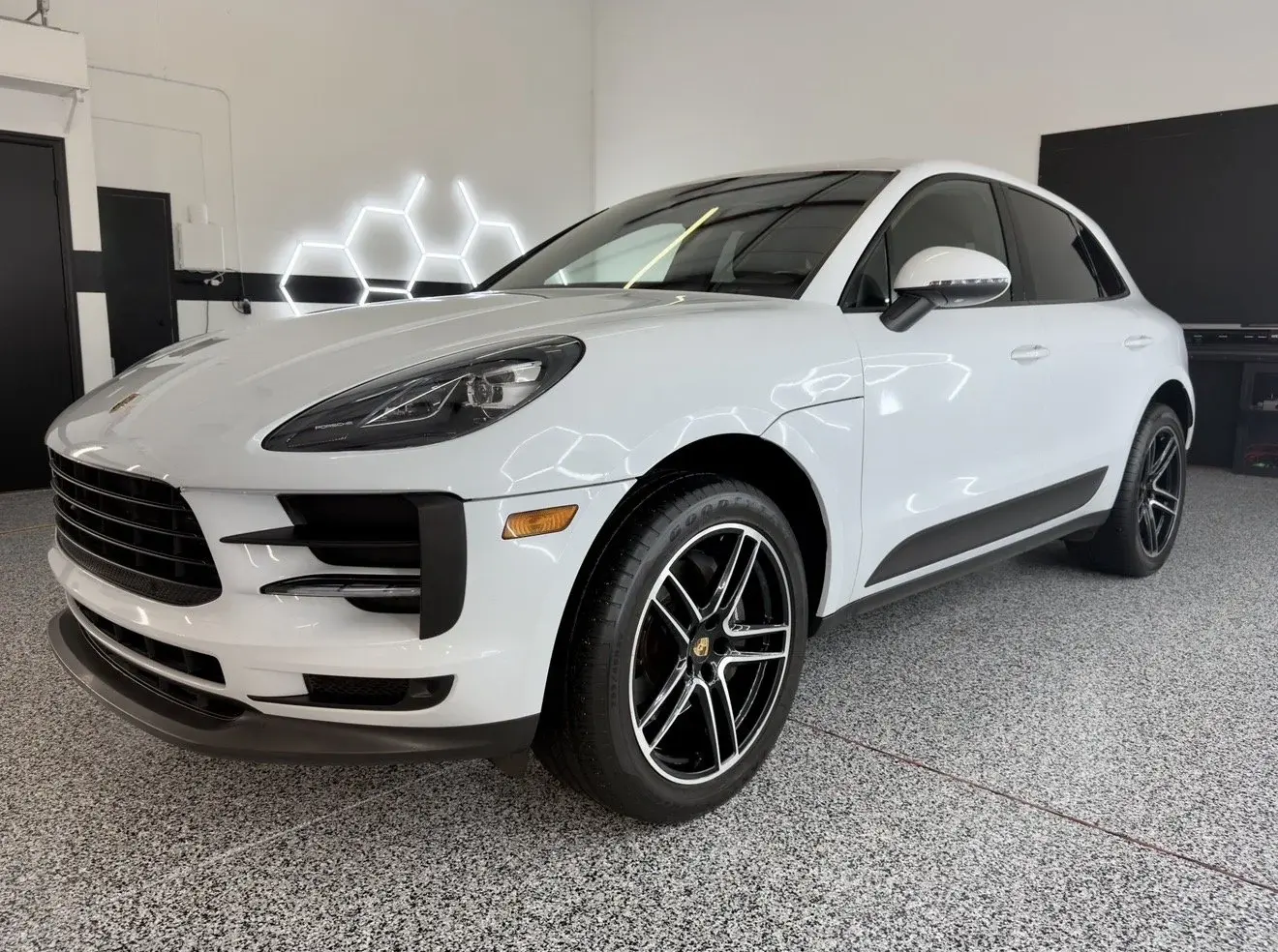 White Porsche Macan in the Gulf Coast Auto Studio bay