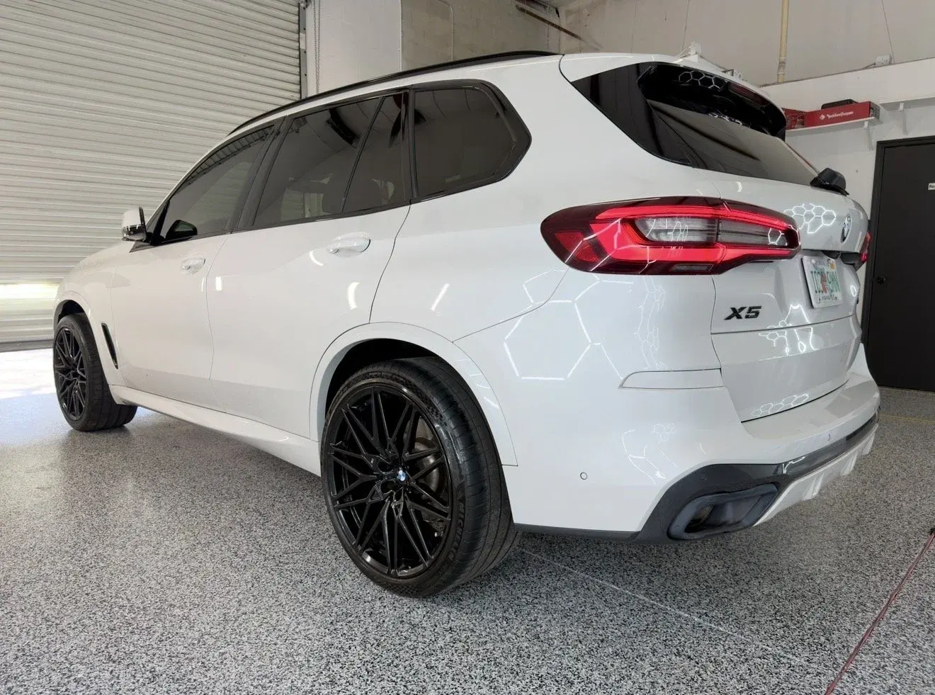 White BMW X5 in the Gulf Coast Auto Studio bay in Sarasota