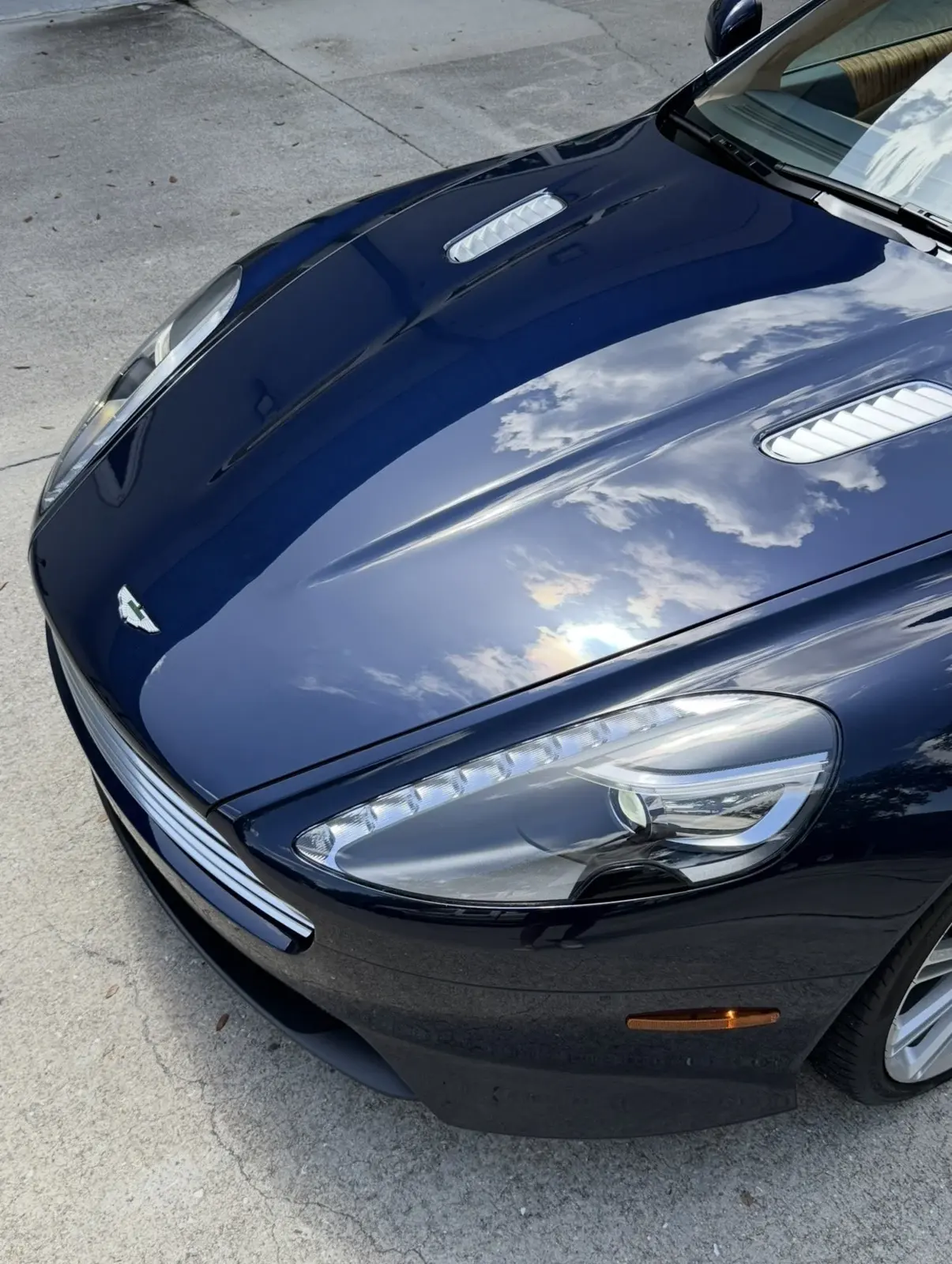 Dark blue Aston Martin under the studio hex lights